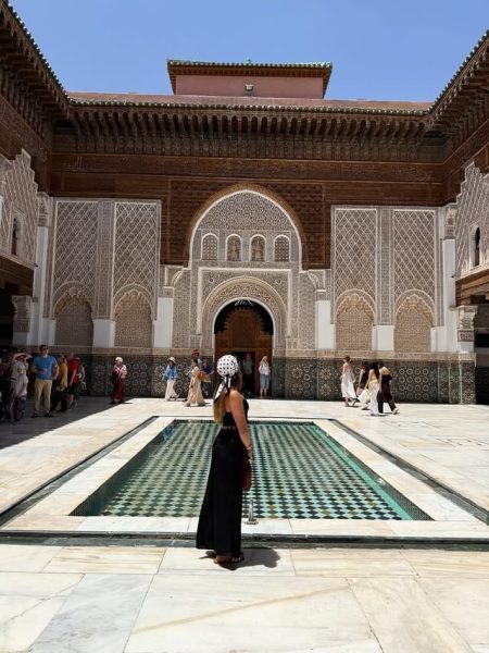 Intricate tilework and carvings inside the Ben Youssef Madrassa courtyard.