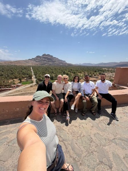 Our group of travelers enjoying the beautiful palm oasis and Moroccan mountain peaks.