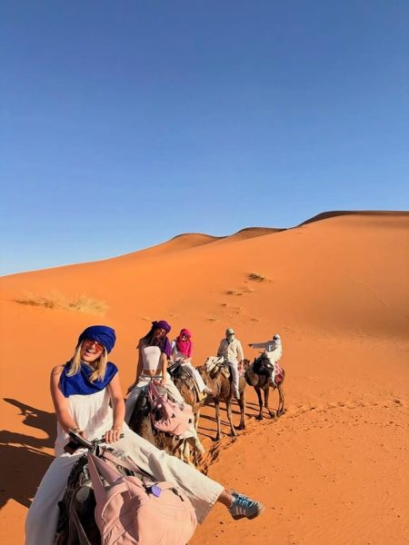 A camel caravan trekking across the Sahara dunes on a 3 day Morocco tour.
