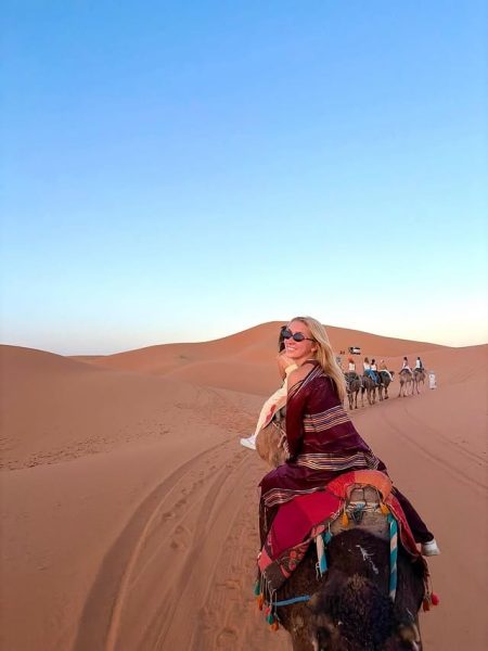 Group of travelers enjoying a camel trek across the Sahara Desert on a 4-day Morocco tour