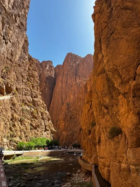Travelers enjoying a short walk through the dramatic Todra Gorges during our 5 day tour from Casablanca