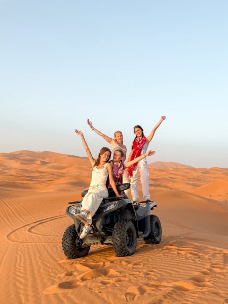 Adventure quad biking through golden sand dunes in Morocco